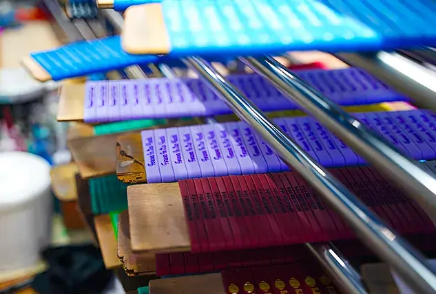 Colorful Screen Printed Materials Drying on Rack